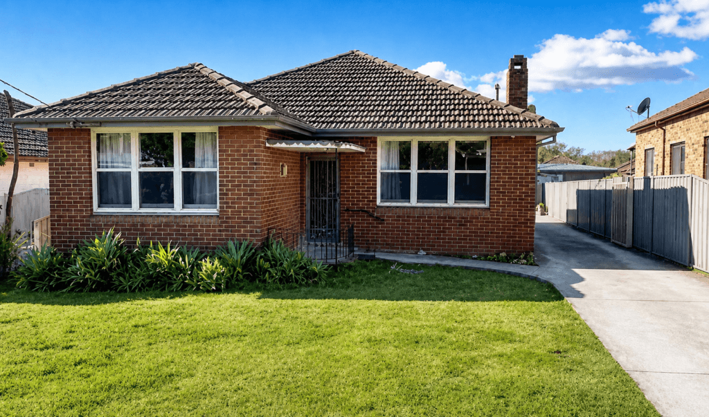 The front of Amigo's Supported Independent Living home in Kingsgrove — a full-brick house with a tiled roof and a front lawn on a quiet residential street
